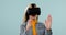 Virtual reality, woman and surprise with 3D experience, scroll with metaverse and future technology on blue background