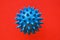 A virus cell. coronavirus, covid 19, blue ball on a red background.