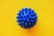 A virus cell. coronavirus, covid 19, blue ball on a yellow background.