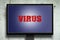 Virus. The inscription on the monitor. Gray concrete background. Technologies