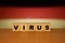 Virus message inscription on a wooden desk on cube blocks with a Germany flag background. Coronavirus