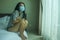 Virus outbreak - young beautiful desperate and worried Asian woman wearing medical face mask