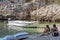 Vis, Croatia - Aug 17, 2020: Females sit on sheltered cove Stiniva beach in summer