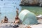 Vis, Croatia - Aug 17, 2020: Tourists sunbathing on sheltered cove Stiniva beach in summer