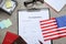 Visa application form, American flag, passports and stationery on wooden table, flat lay