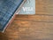 Visa card in blue jeans wallet on brown wooden table.