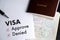 Visa and passport to approved stamped on a document top view in