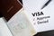 Visa and passport to approved stamped on a document top view in