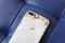 VISAGINAS, LITHUANIA - MARCH 30, 2019: The back side of a broken iPhone 8 Plus is white and gold on a blue leather background