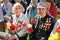 VISAGINAS, LITHUANIA - MAY 09, 2011: Grandmother and Grandfather Veterans of the Great Patriotic Second World War with flowers, me