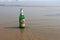 Visakhapatnam, Andhra Pradesh on 16th March in 2016 : An empty beer bottle lying down on the sand in Vizag Yarada beach.