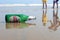 Visakhapatnam, Andhra Pradesh on 16th March in 2016 : An empty beer bottle lying down on the sand in Vizag Yarada beach.