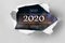 Vision 2020 goal written behind a torn paper. Top view of white torn paper and the text `2020` on a background.