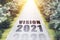 Vision 2021 written on highway road in the middle of empty asphalt road