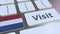 VISIT text and flag of the Netherlands on the buttons on the computer keyboard. Conceptual 3D animation
