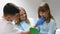 Visiting the dentist with children. A little girl is sitting in a dental clinic with her mother