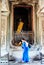Visitor in blue dress in Historic building in Angkor wat Thom Cambodia