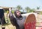 A visitor of a knight festival dressed in the armor of a medieval warrior posing for photographers in Goren park in Israel