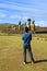 Visitor looking at the 15 huge Moai statues of Ahu Tongariki, Archaeological site on Easter Island, Chile