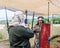 A visitor to a knight festival poses for a photographer in the form of a Roman legionary in Goren park in Israel