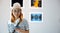 Visitor woman smiling at picture art gallery collection in front framed paintings pictures she