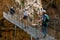 Visitors crossing the suspension bridge at Gaitanes Gorge, Malaga, Spain