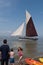 Visitors enjoy Whitstable beach and sea Kent, UK