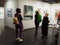 Visitors enjoying contemporary artworks displayed in a gallery for the Discovery Art Fair Frankfurt