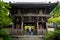 Visitors looking at the gate entrance with nio kings statues in the wooden building at Daisho-in temple in Miyajima, HIroshima,