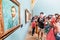 Visitors looking at Van Gogh paintings in a showroom of museum