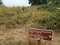 Visitors must use walking trail sign and brown grass