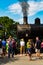 Visitors near smoky steam locomotive