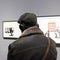 Visitors observe Banksy`s street works in an unauthorized exhibition in a museum