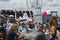 Visitors sit by the harbour to sample oysters at the Whitstable Oyster Festival