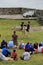 Visitors sitting or standing near young men reenacting the firing of muskets,Fort Ticonderoga,New York,2014