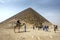 Visitors to Dahshur in northern Egypt stand beside the Red Pyramid.