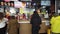 Visitors to a food court in a mall wait and receive an order - pancakes at a McDonald`s