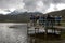 Visitors to Laguna de Limpiopungo in Ecuador stand on a jetty overlooking the lake.