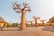 Visitors and tourists with families and children near famous Baobab trees in African Village at