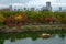 Visitors on a tram and cruise boat enjoying autumn season colours at Osaka Castle Park in Osaka, Japan