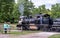 Visitors watch as a vintage steam engine drives by