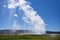 Visitors watch the famous geyser Old Faithful on a sunny day at Yellowstone National Park, which is the first national park in the