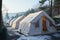 Visitors winter haven White camping tents at a mountain resort