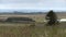 Vista of farmland with a distant river in the background