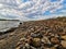 Vistula river on the outskirts of the city, wonderful spring scenery of Masovian landscape, colorful stones on the river bank