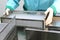 Visual control of ampoules with medicine. A woman works on an ampoule production line. Sterile bottles and ampoules on