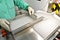 Visual control of ampoules with medicine. A woman works on an ampoule production line. Sterile bottles and ampoules on