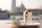 A visually appealing shot of a panna cotta dessert, with the historic Leaning Tower of Pisa gently out of focus in the backdrop.