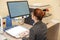 A visually impaired woman uses special reading equipment