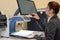 A visually impaired woman uses special reading equipment